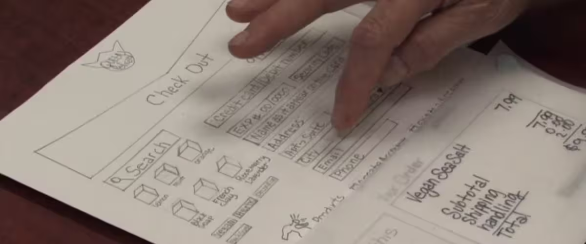 Usability session — participant reviewing Queen Pelican paper prototype